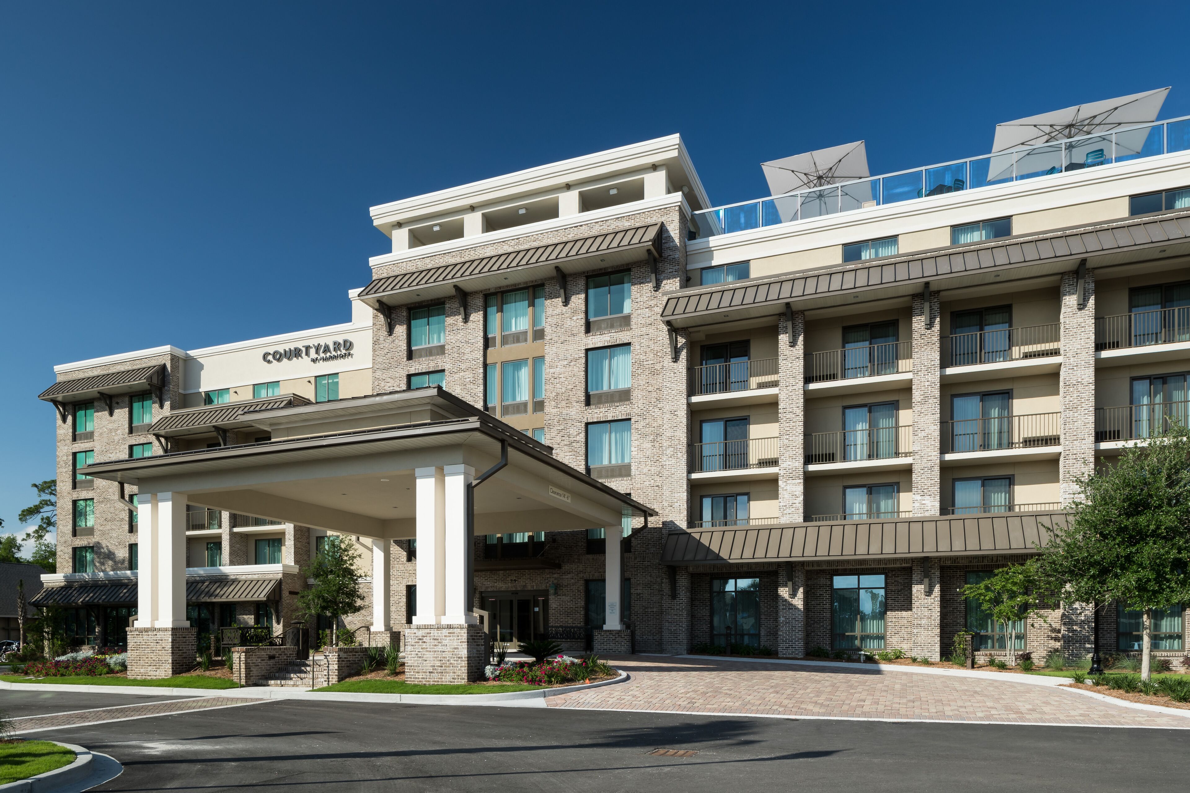 A multi-story hotel with a covered entrance, large windows, and a prominent 'Courtyard' sign.
