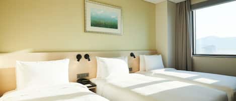 A hotel room with two beds, a nightstand, a painting on the wall, and a window with curtains.