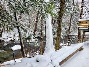 A bench overlooking a snow-covered forest with a stream. - Escape on the river (French Creek)