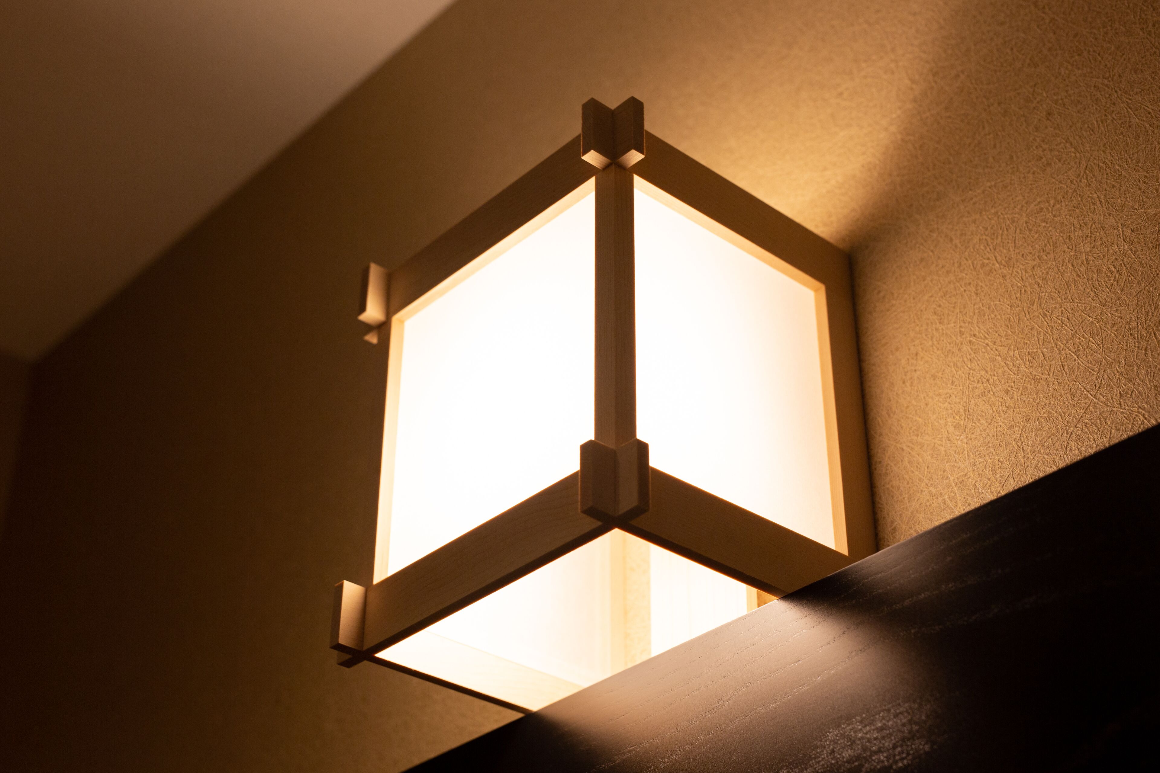 A wall-mounted light fixture with a geometric design.