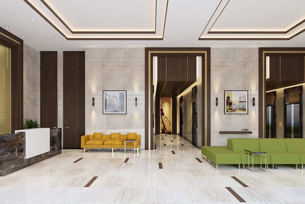 A modern lobby with a reception desk, two sofas, and a marble floor. - KYN Apartment Rivergate Residence (Ho Chi Minh City)