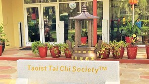 Een stenen bord met de tekst 'Taoist Tai Chi Society™' en een websiteadres.