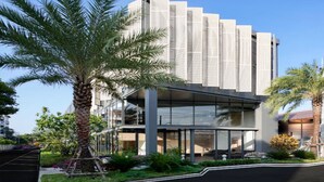 A modern building with a glass facade, surrounded by palm trees and landscaped gardens. - Canalis Suvarnabhumi Airport Hotel – Free Scheduled shuttle from Hotel to Suvarnabhumi Airport (Bangkok)