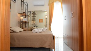 A bedroom with a bed, a wardrobe, a ladder, and a mirror. - City House. Life in the center. (Campofelice di Roccella)