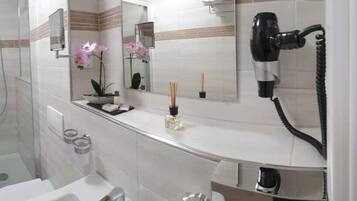 Shower, hair dryer, slippers, towels