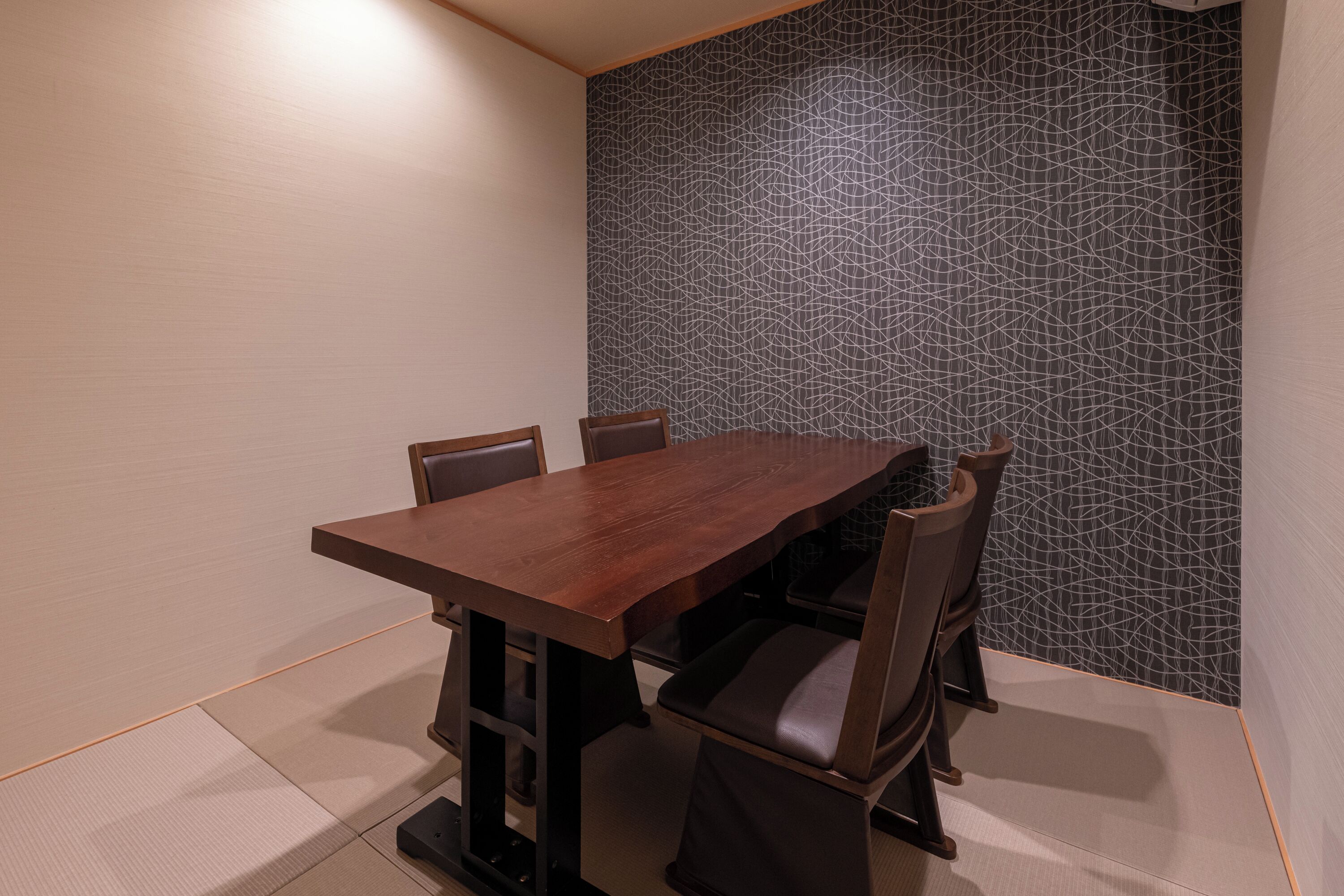 A dining area with a rectangular table and four chairs.