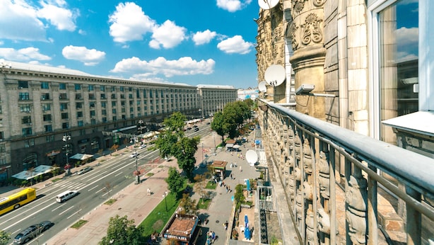 A high-rise building with a long facade, large windows, and a street view below. - Apartments Kreshchatik 17-39 (Kyiv)