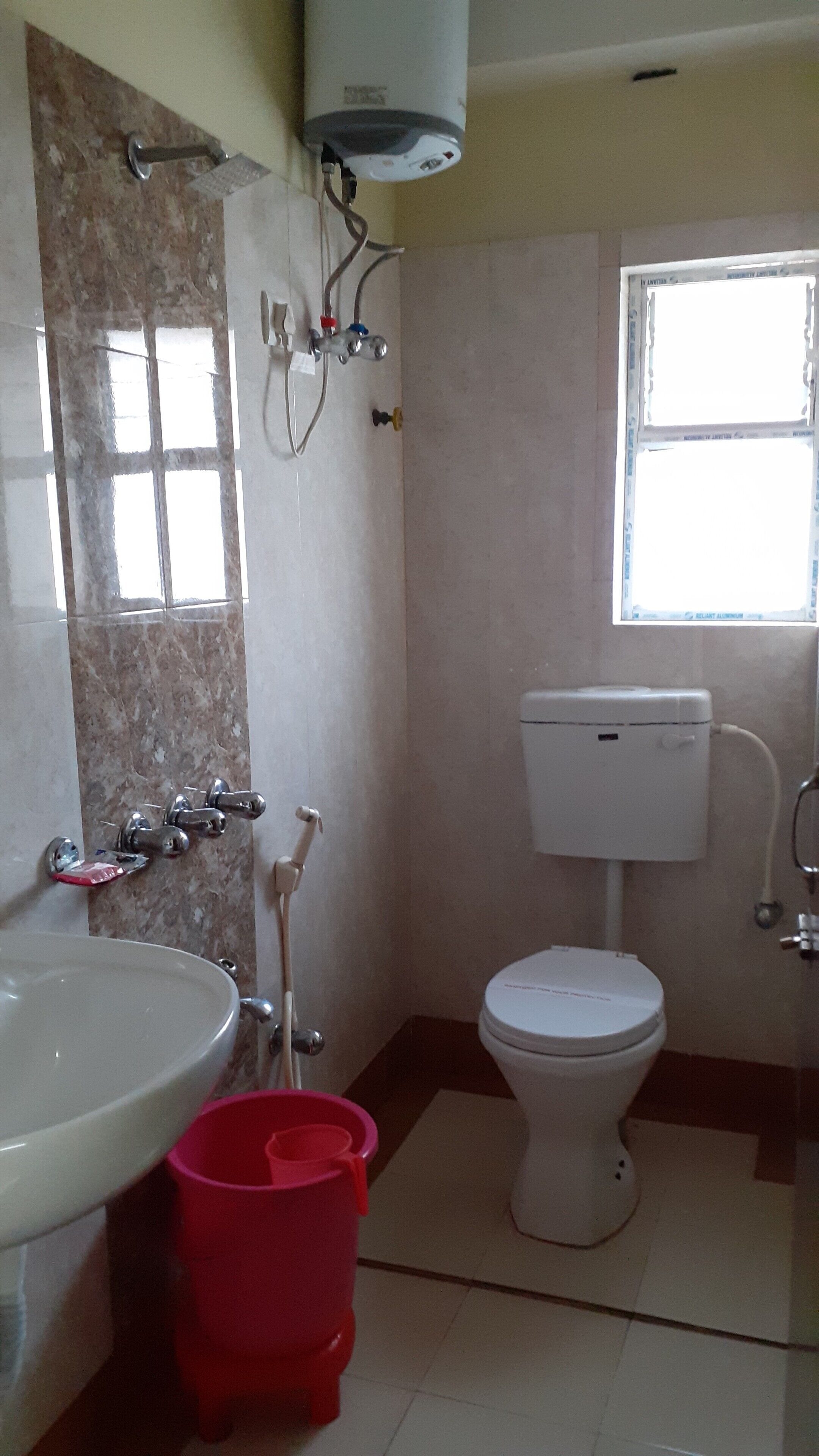 A bathroom with a sink, toilet, and shower.