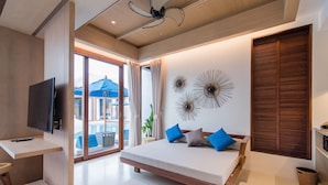 A modern bedroom with a bed, a TV, and a view of the outside. - Lullaby The Sea Hua Hin (Cha-am)