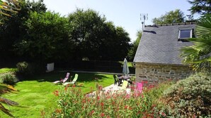 A stone house with a sloped roof, a small window, and a satellite dish. - Holiday Home in Guerlesquin near Lake (Guerlesquin)