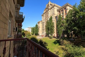 A multi-story building with a classical architectural style, featuring balconies and a central courtyard.