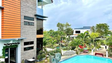 2 outdoor pools, open 7:00 AM to 10:00 PM, pool loungers