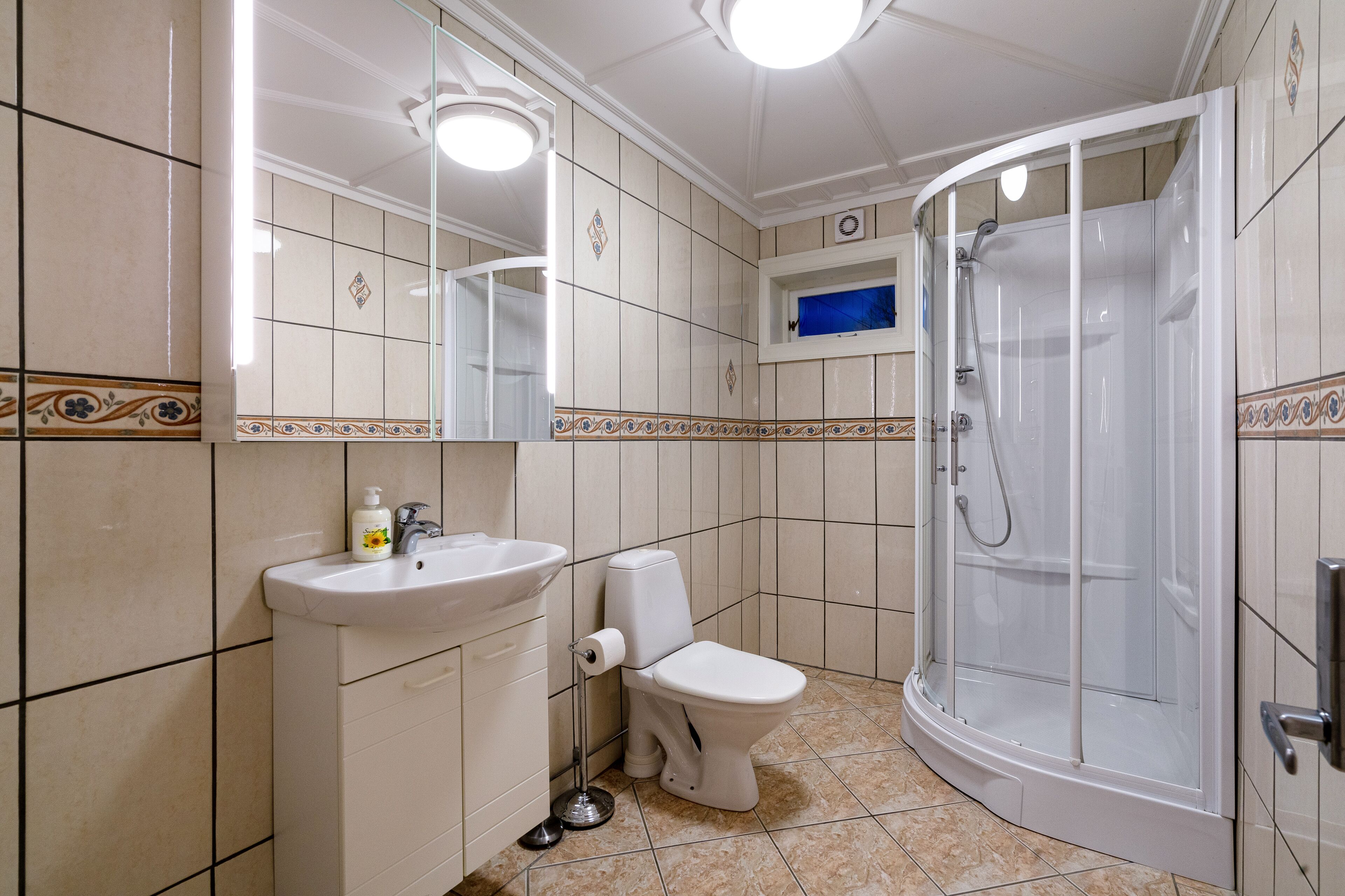 A bathroom with a sink, toilet, and shower.