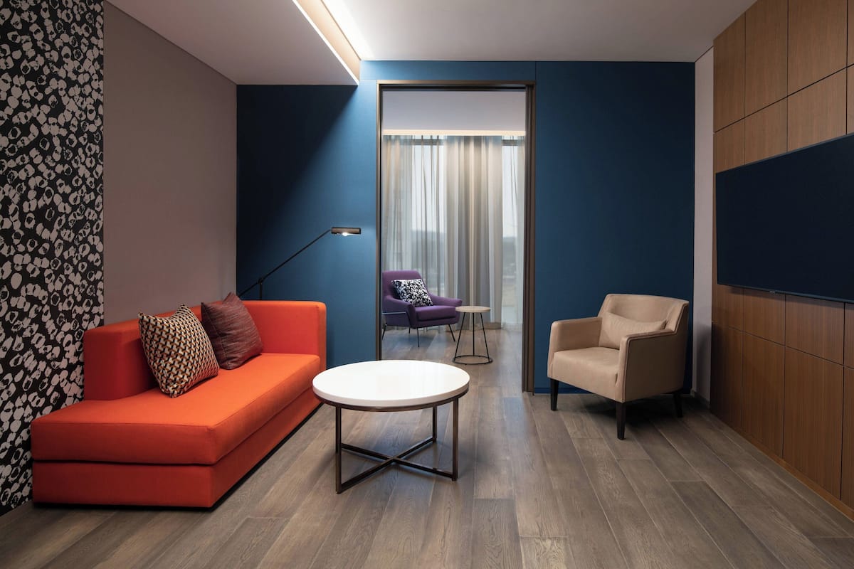 premier suite, 1 king bed, non smoking | living room | 55-inch led tv with cable channels, tv