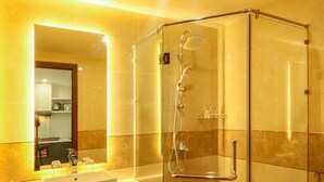 A modern bathroom with a glass-enclosed shower, a large mirror, and a white sink. - Citypoint Apartment (Da Nang)