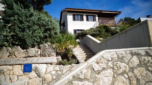 A stone staircase leading to a white building with a balcony. - Nice Studio apartments Eduard (Medulin)