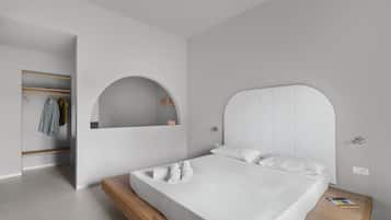 Ein modernes Schlafzimmer mit einem Bett, einem eingebauten Kleiderschrank und einem Spiegel.