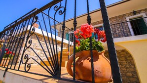 A terracotta pot with red flowers on a balcony railing. - Stunning Villa Bozini Dvori (Sveti Filip i Jakov)