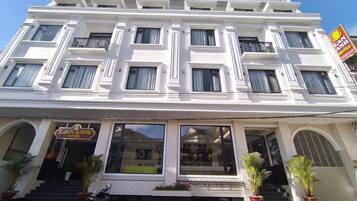 A multi-story hotel with a white facade, large windows, and a sign indicating it is the Lananh Hotel.