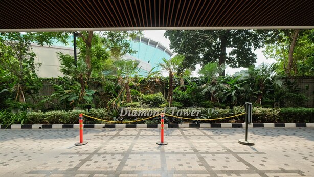 A paved area with a rope barrier and a sign reading "Diamond Tower." - Cozy Studio Room Apartment Menteng Park (Jakarta)