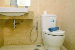 Une salle de bain avec un lavabo, des toilettes et une douche.
