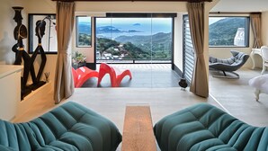 A modern living room with a view of a mountainous landscape through large windows. - Windsor's Sunlight Han-Guan (New Taipei City)