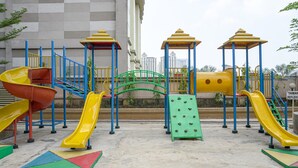 A playground with multiple slides and climbing structures. - Brand New and Modern 3BR Grand Palace Kemayoran Apartment (Jakarta)