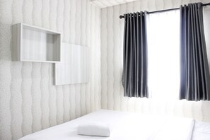 Relax in a stylishly designed room with a comfortable bed, ample storage, and a large window.