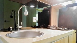 Een moderne badkamer met een wastafel, spiegel en douche.