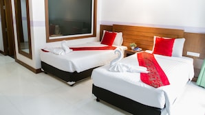 Two double beds with white and red bedding, a wooden headboard, and a large window. - Diamond Crown Hotel Patong (Patong)