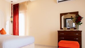 A bedroom with a bed, a dresser, and a mirror. - Villa Naya Branch 5 Saray (Al Rama)