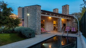 A stone building with a swimming pool, lounge chairs, and a patio area. - Pet friendly home in Fazana (Fazana)