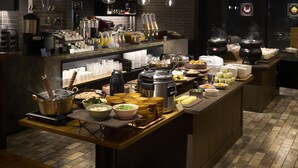 A buffet setup with various food items and cooking equipment. - Resol Hotel Trinity Osaka (Osaka)