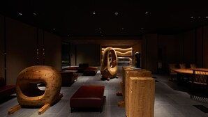 A modern interior with unique wooden furniture, red seating, and a spacious layout. - Resol Hotel Trinity Osaka (Osaka)