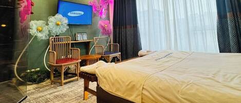 Un dormitorio moderno con una cama, un televisor y paraguas decorativos.