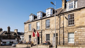A historic stone building with multiple windows and a corner entrance. - The Dunvegan Hotel (St. Andrews)
