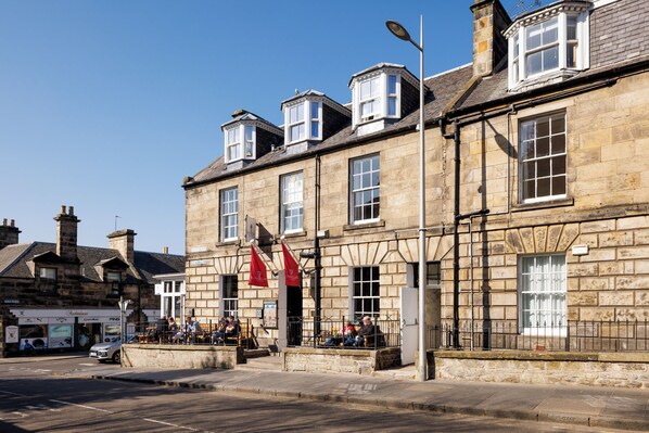 A historic stone building with multiple windows and a corner entrance. - The Dunvegan Hotel (St. Andrews)