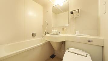 A bathroom with a bathtub, sink, mirror, and toilet.