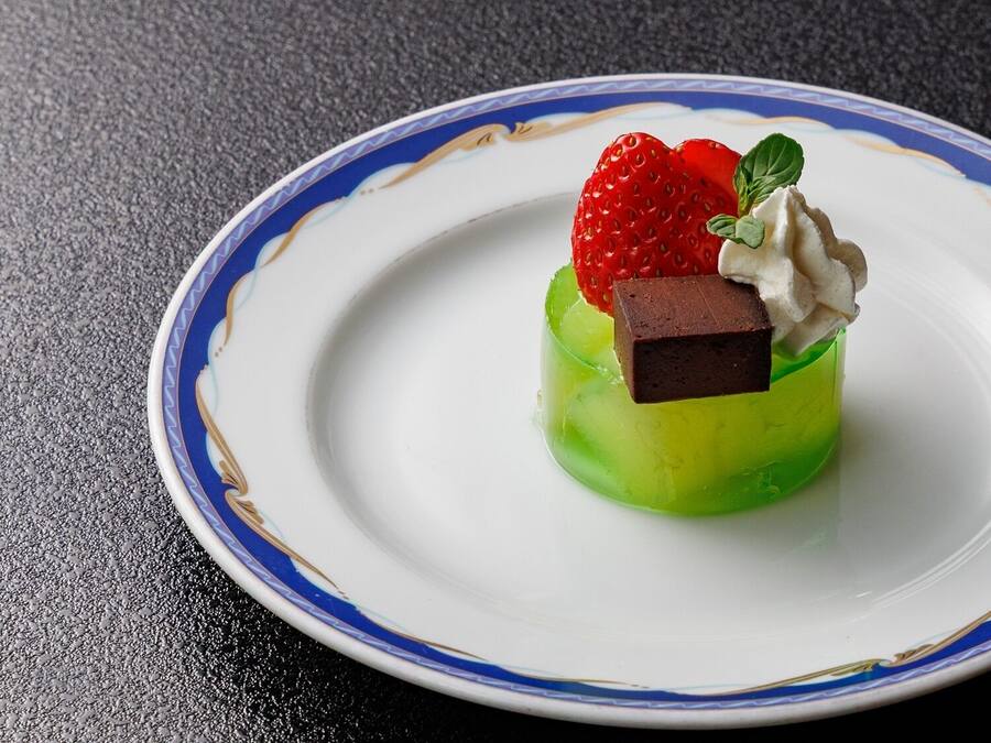 A dessert on a plate with a blue and gold rim.