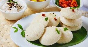 A plate of idlis with chutney and sambar. - Hotel Temple City (Madurai)