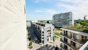 A modern building with multiple floors, large windows, and a flat roof. - Domitys Emerald Haven (Antwerp)