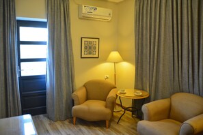 Deluxe Suite, Balcony | Living area