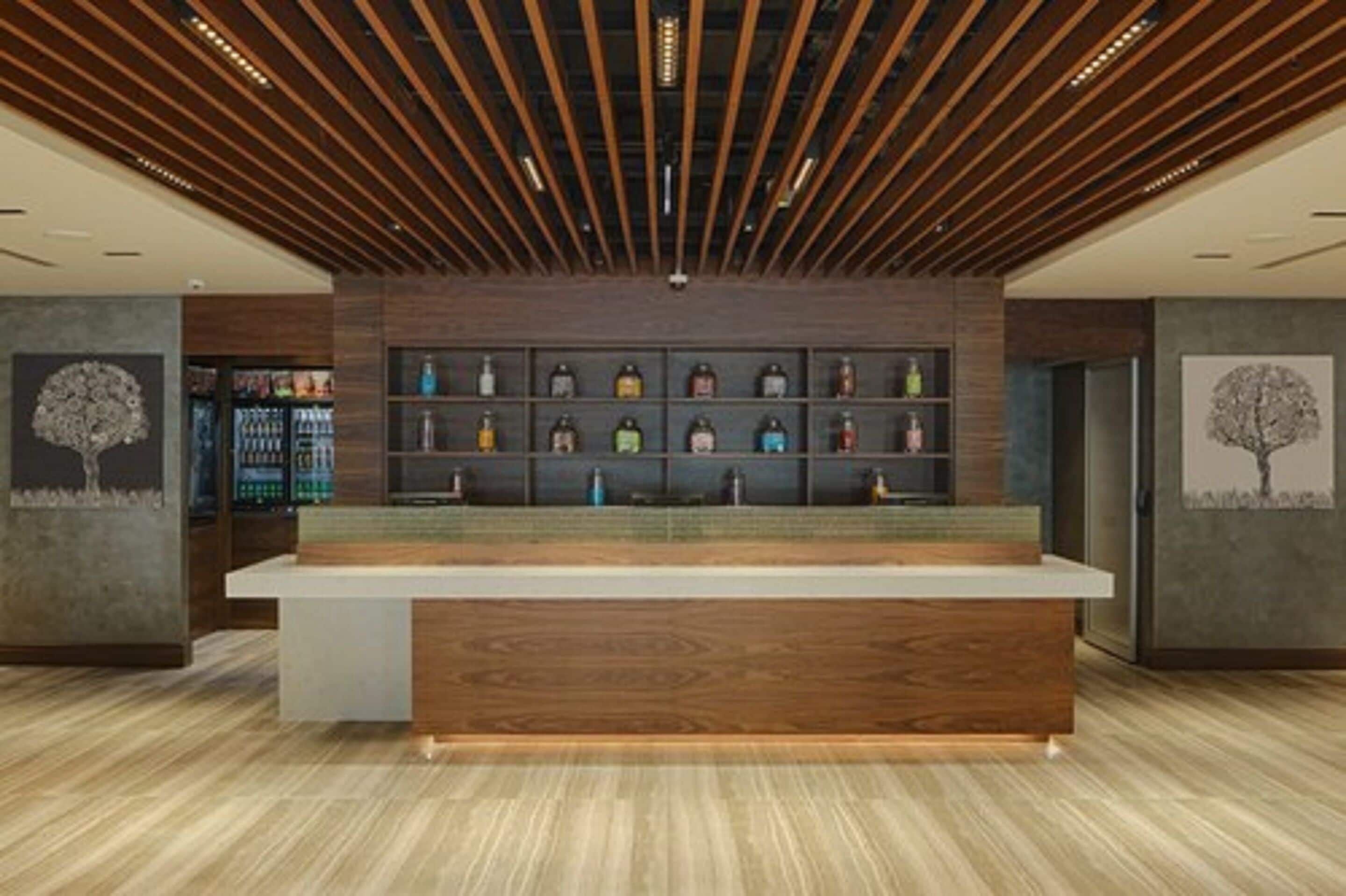 A modern reception area with a wooden reception desk, a wall-mounted shelf with various items, and a ceiling with wooden slats.