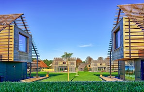 A modern building with a sloped roof and a central courtyard.
