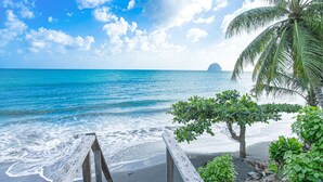 A wooden staircase leading to a beach with clear blue water and a palm tree. - Villa Leynita Bay, 5 bedrooms, sleeps 12 on the beach of Diamant Martinique  (le diamant)