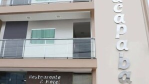 A multi-story building with a sign reading "acapaba" and a restaurant sign below it.