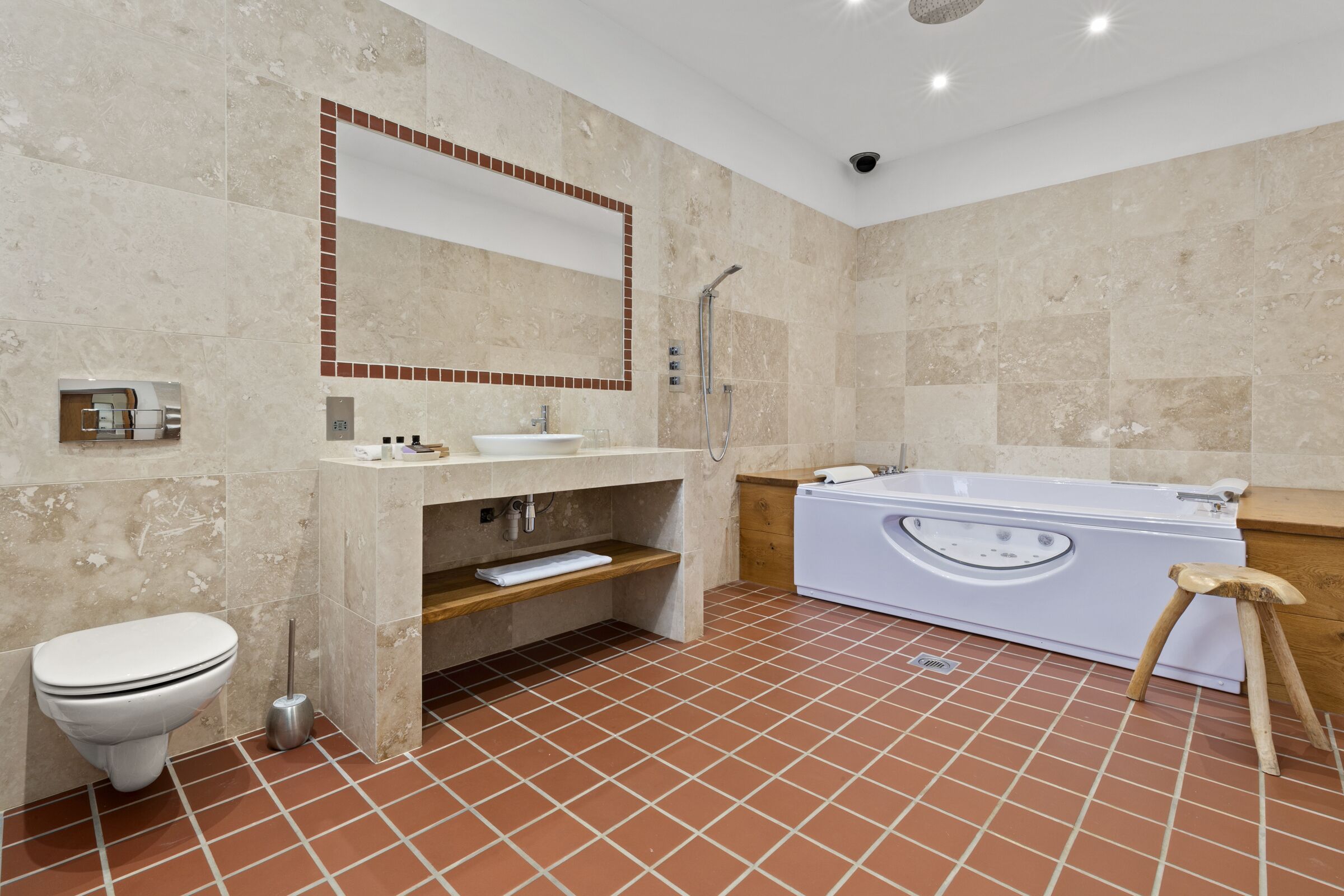 A modern bathroom with a toilet, sink, and bathtub.