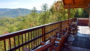 A wooden deck with a view of a forested mountain range. - Papa Bear's Den - Cabin (Sevierville)