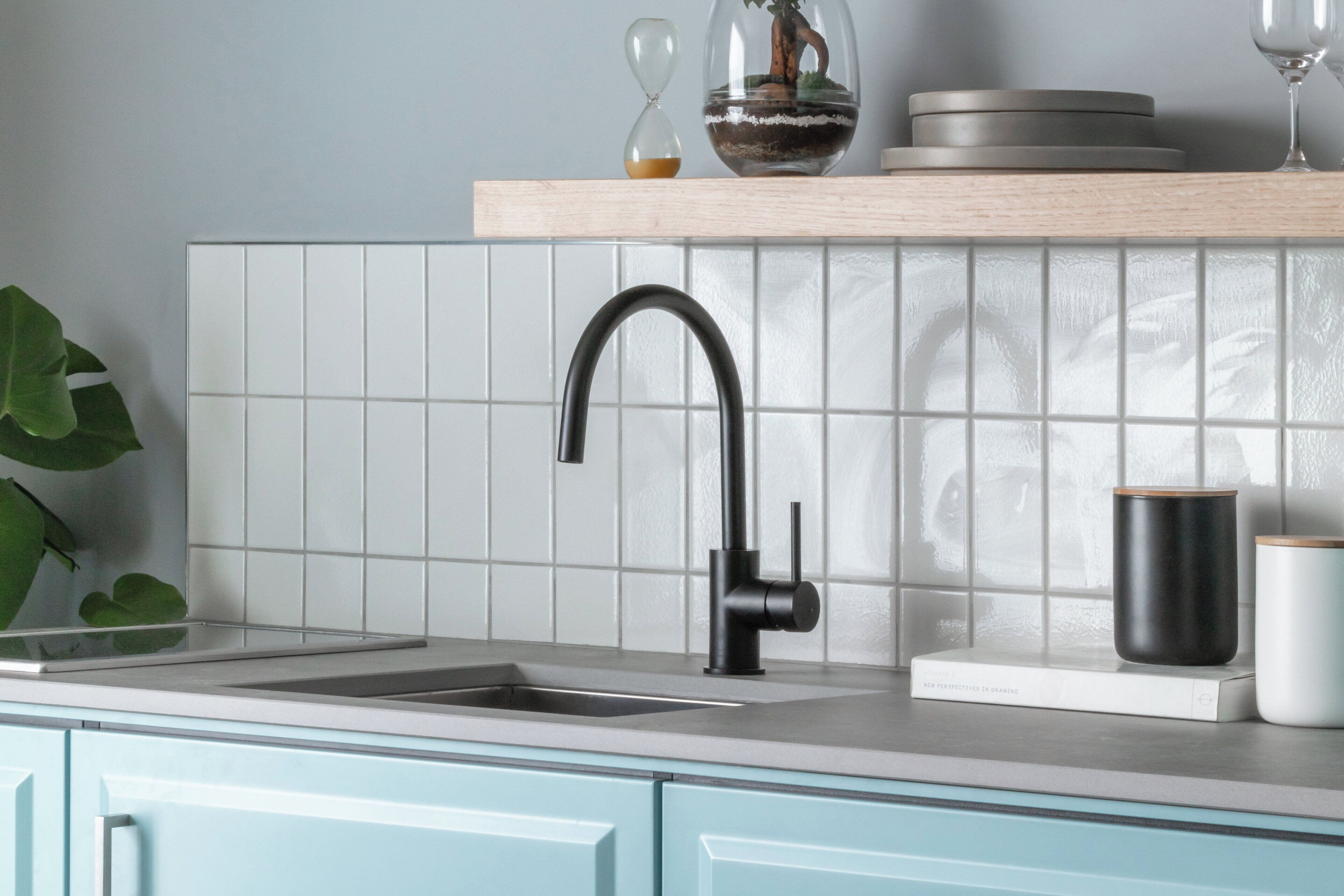 A kitchen with a modern faucet, a sink, and a window with a view.