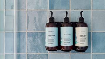 Three bottles of Shore Soap Co. products against a tiled wall.